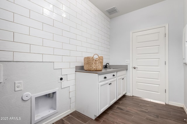 laundry room featuring cabinet space, visible vents, electric dryer hookup, and wood finish floors