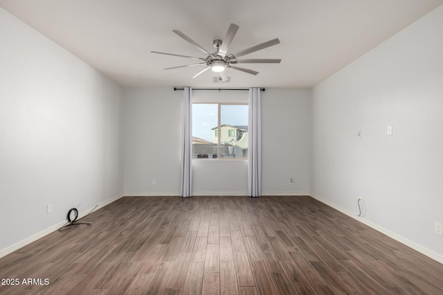 empty room featuring ceiling fan, wood finished floors, visible vents, and baseboards