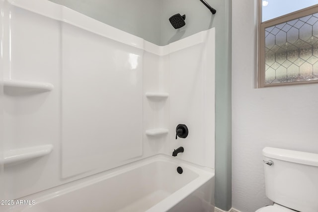 bathroom featuring toilet and shower / bathing tub combination