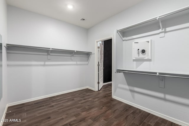 spacious closet featuring visible vents and dark wood finished floors