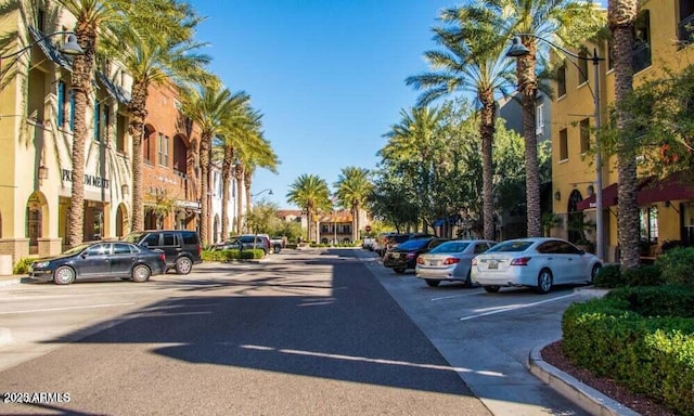 view of road featuring a residential view, curbs, and street lights