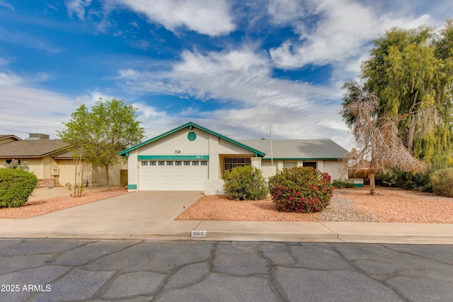 ranch-style home featuring an attached garage and concrete driveway