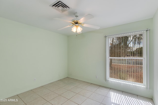 spare room featuring light tile patterned floors, a ceiling fan, and visible vents