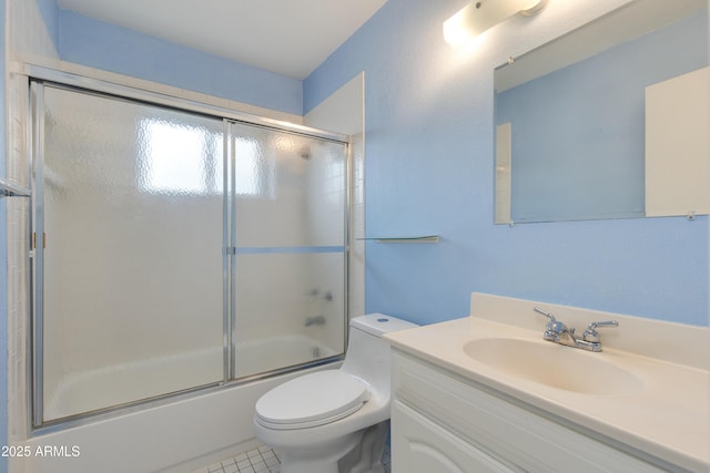 full bath with tile patterned floors, enclosed tub / shower combo, toilet, and vanity