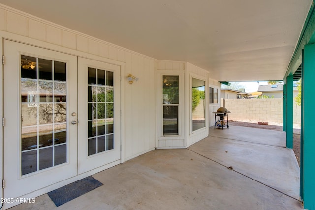 view of patio featuring grilling area, french doors, and fence