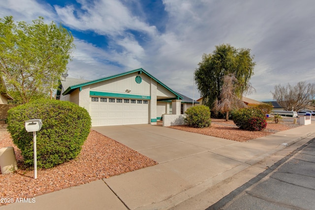 single story home with driveway and a garage