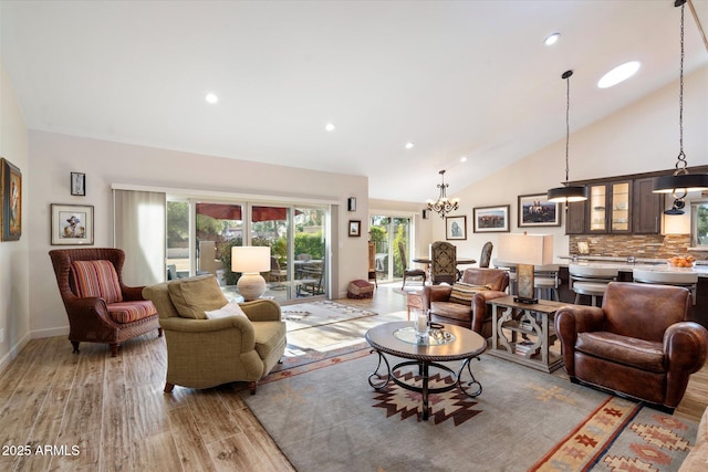 living area featuring light wood-type flooring, baseboards, high vaulted ceiling, and recessed lighting