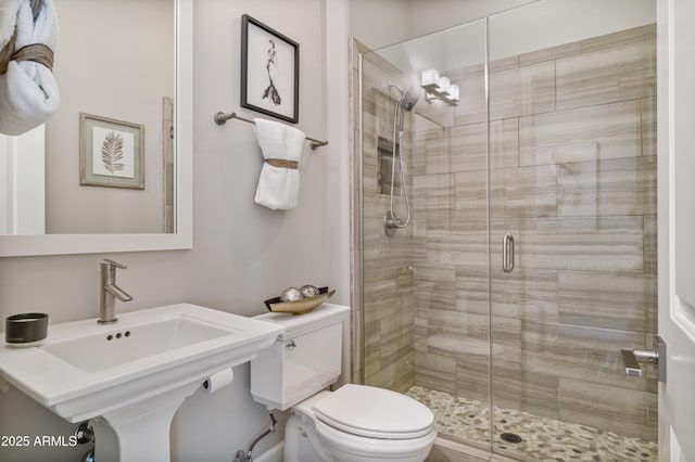 bathroom with toilet, walk in shower, and sink