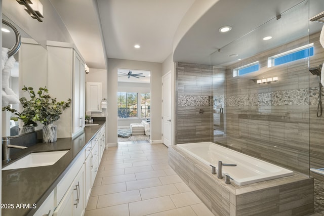 bathroom featuring tile patterned flooring, vanity, ceiling fan, and shower with separate bathtub