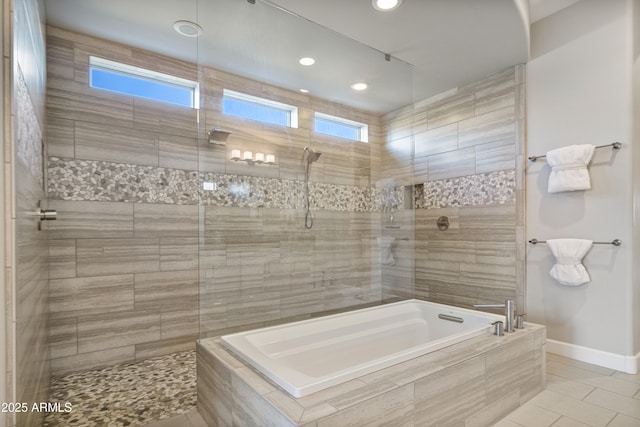 bathroom featuring tile patterned floors and independent shower and bath