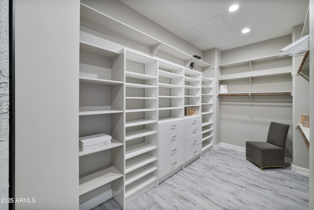 walk in closet with light wood-type flooring