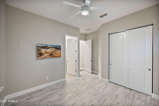 unfurnished bedroom featuring light hardwood / wood-style floors, a closet, and ceiling fan