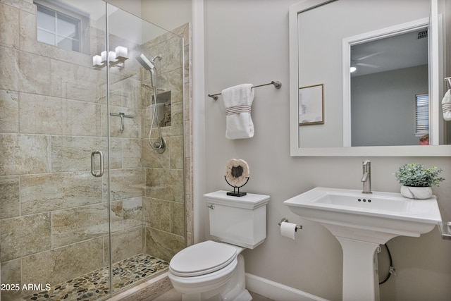 bathroom with sink, an enclosed shower, and toilet