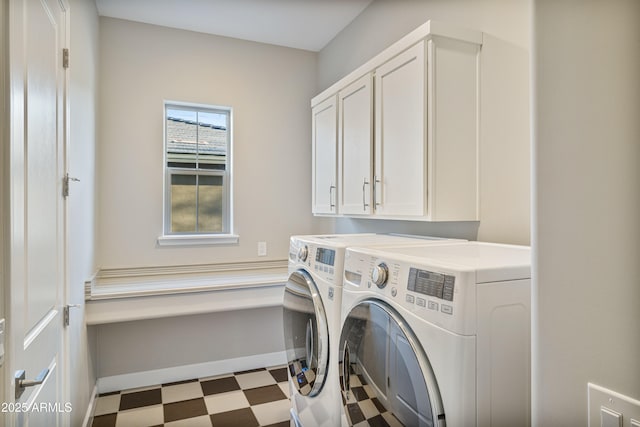 laundry room with cabinets and washing machine and clothes dryer