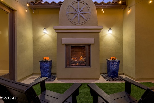 property entrance with an outdoor fireplace