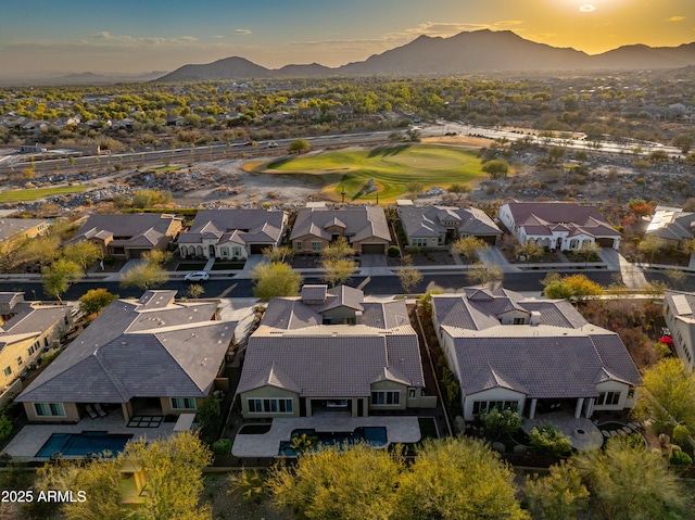 aerial view at dusk featuring a mountain view