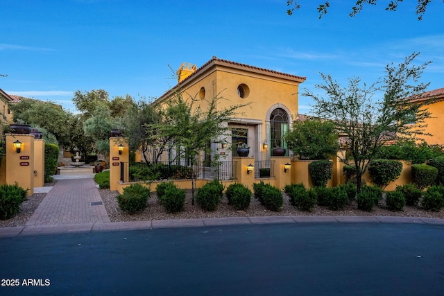 18927 N 101st St, Scottsdale, AZ 85255 - mediterranean / spanish-style house with stucco siding, a fenced front yard, and a gate