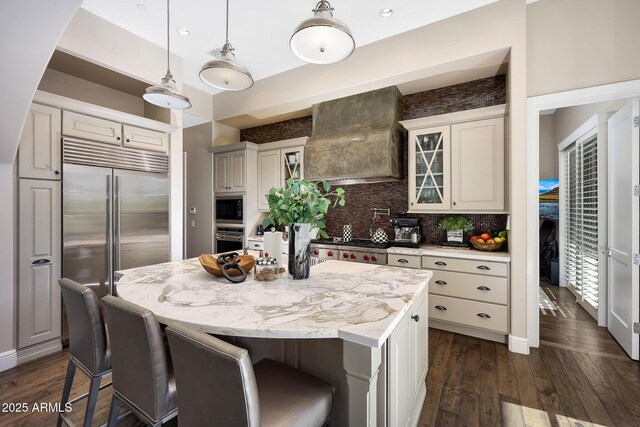18927 N 101st St, Scottsdale, AZ 85255 - kitchen with built in appliances, wall chimney exhaust hood, dark wood finished floors, and a center island