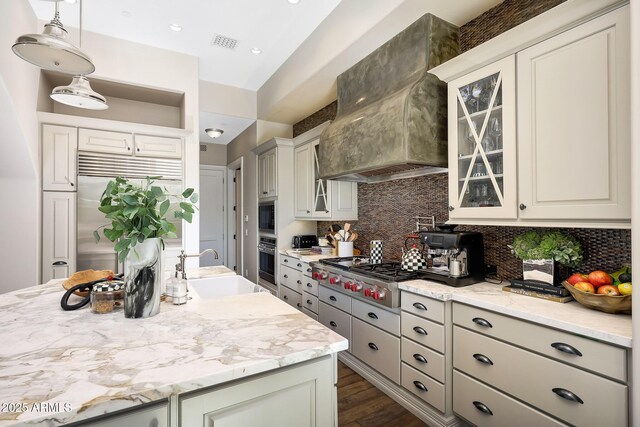 18927 N 101st St, Scottsdale, AZ 85255 - kitchen featuring custom exhaust hood, a sink, stainless steel appliances, tasteful backsplash, and glass insert cabinets