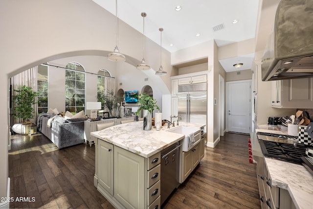 18927 N 101st St, Scottsdale, AZ 85255 - kitchen with stainless steel appliances, dark wood-style flooring, range hood, a sink, and a towering ceiling