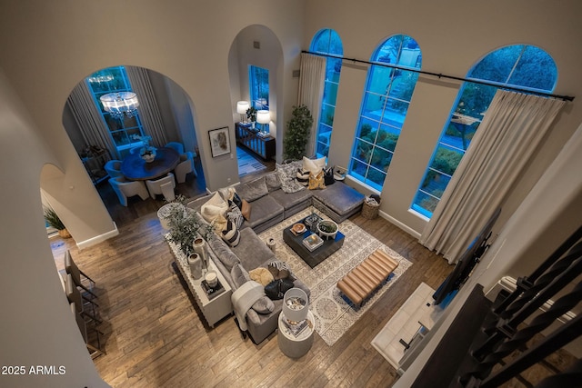 18927 N 101st St, Scottsdale, AZ 85255 - living area featuring arched walkways, wood finished floors, and baseboards