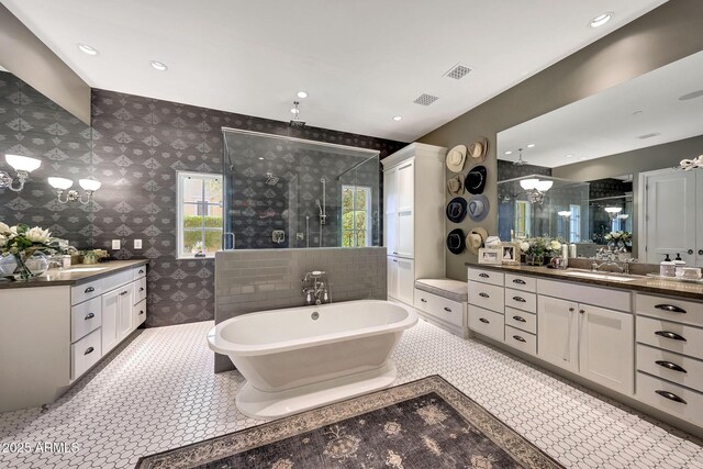18927 N 101st St, Scottsdale, AZ 85255 - bathroom with a stall shower, plenty of natural light, two vanities, a freestanding bath, and wallpapered walls