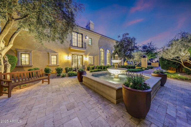 18927 N 101st St, Scottsdale, AZ 85255 - patio terrace at dusk featuring french doors
