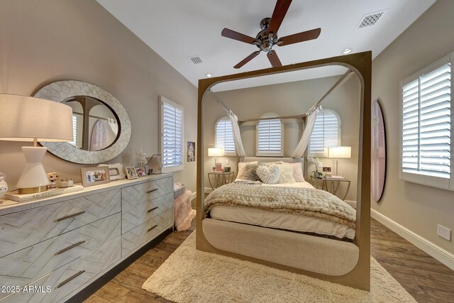 18927 N 101st St, Scottsdale, AZ 85255 - bedroom featuring wood finished floors, multiple windows, lofted ceiling, baseboards, and a ceiling fan