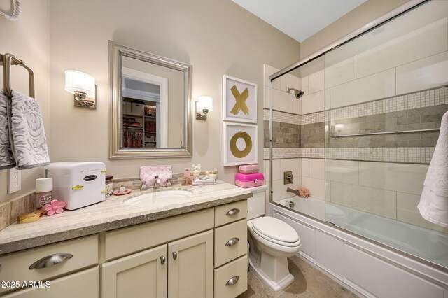 18927 N 101st St, Scottsdale, AZ 85255 - bathroom featuring toilet, vanity, and bath / shower combo with glass door