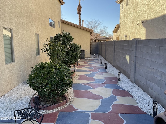 view of side of property featuring a patio and cooling unit