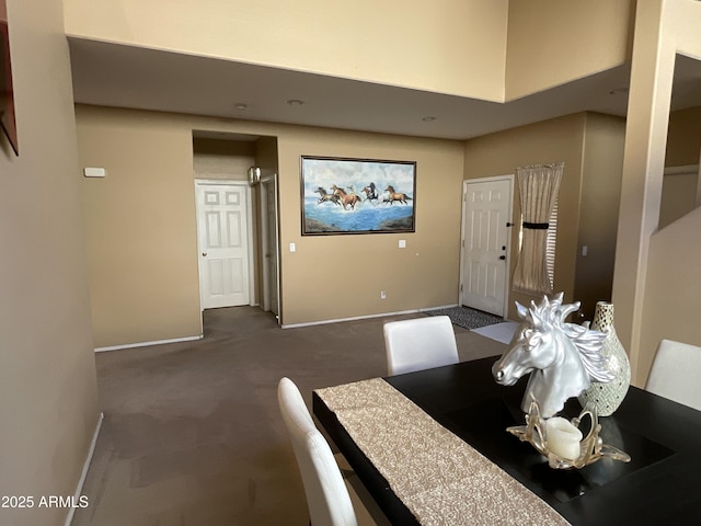 unfurnished dining area with dark carpet