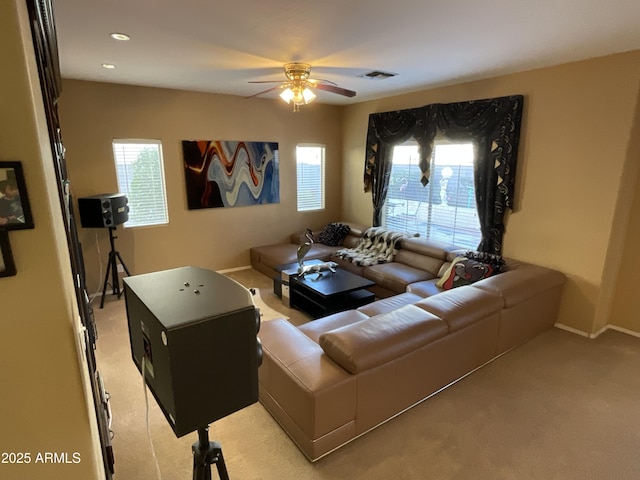 living room featuring ceiling fan and light colored carpet