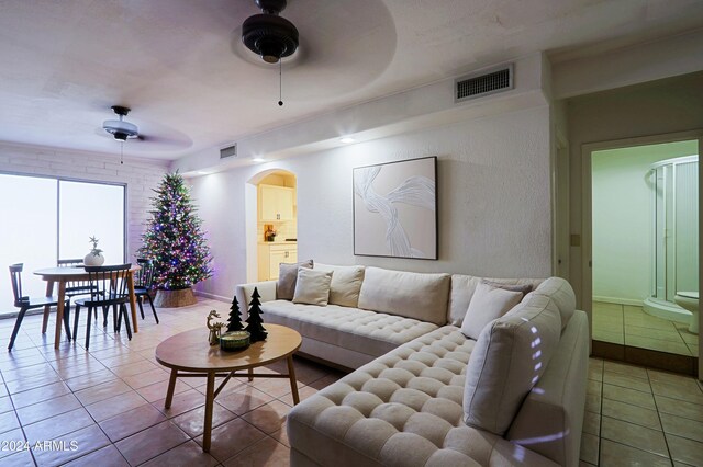 tiled living room featuring ceiling fan