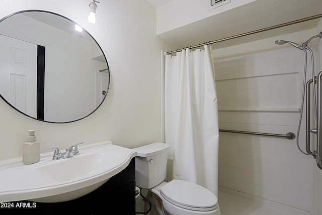 bathroom with vanity, toilet, and walk in shower