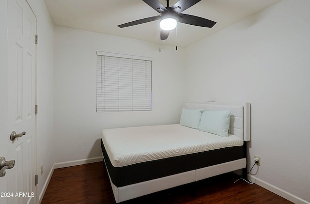 bedroom featuring ceiling fan and dark wood-type flooring