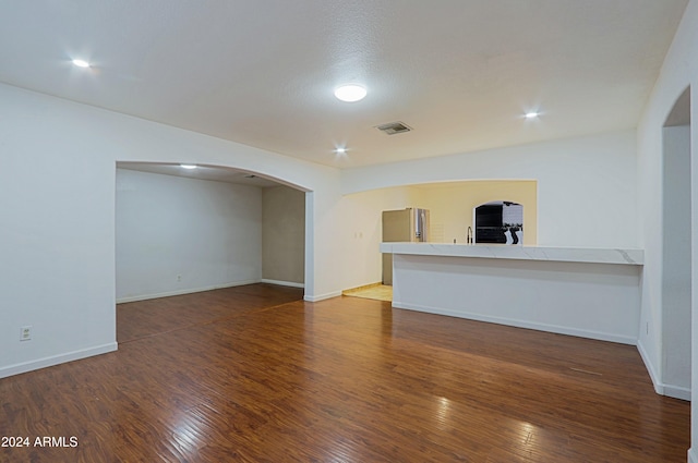 unfurnished living room featuring dark hardwood / wood-style flooring