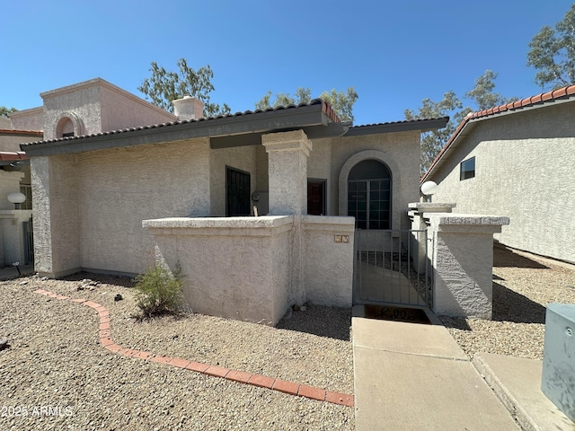1718 S Longmore St Unit 53, Mesa, AZ 85202 - property entrance featuring a gate and stucco siding
