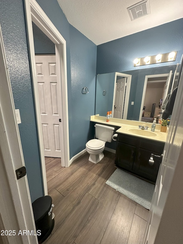 1718 S Longmore St Unit 53, Mesa, AZ 85202 - bathroom with a textured wall, wood finished floors, vanity, and a textured ceiling