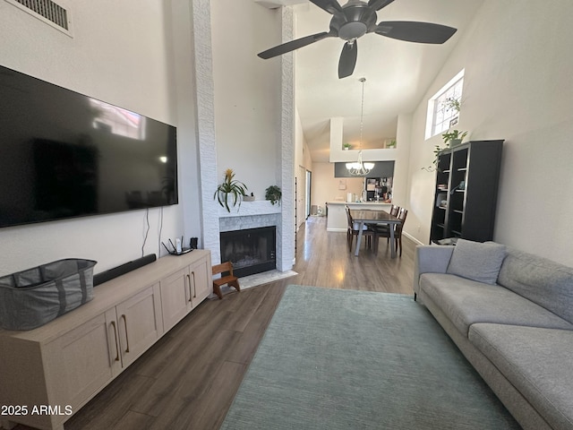 1718 S Longmore St Unit 53, Mesa, AZ 85202 - living room with high vaulted ceiling, dark wood finished floors, a chandelier, ceiling fan, and a fireplace with flush hearth