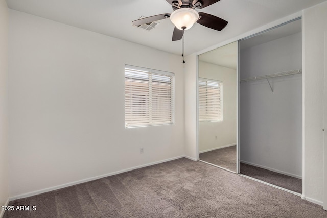 unfurnished bedroom with a closet, a ceiling fan, carpet, and baseboards