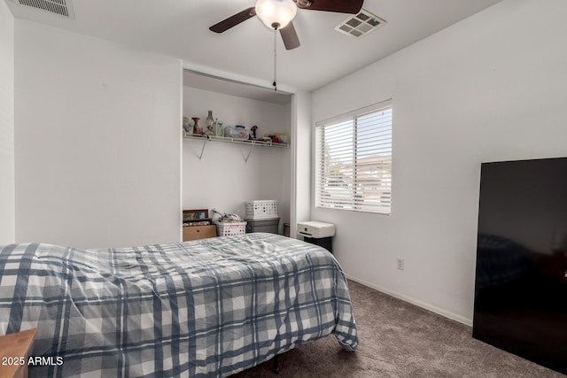 carpeted bedroom with ceiling fan, visible vents, and baseboards