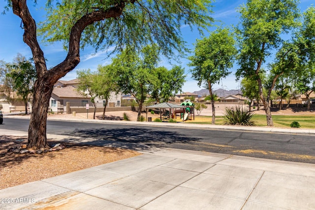 view of street featuring a residential view, sidewalks, and curbs