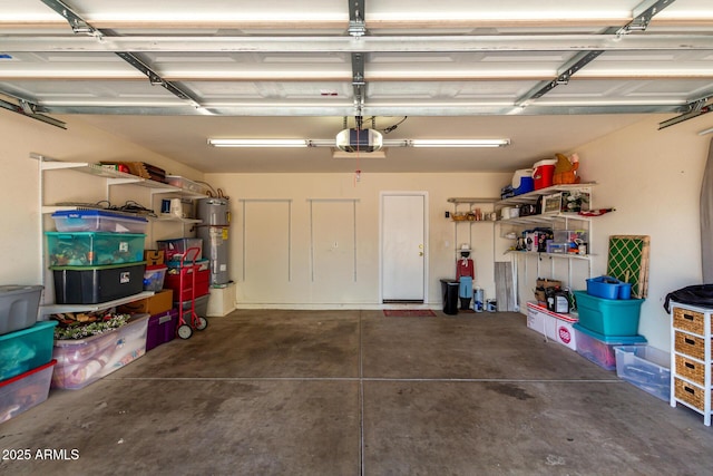 garage featuring a garage door opener and electric water heater