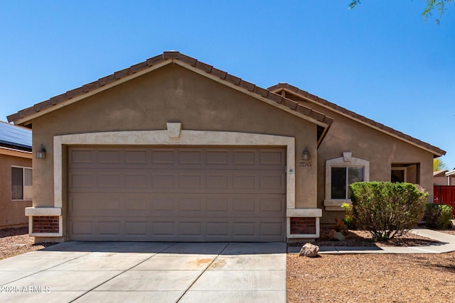 single story home with an attached garage, driveway, and stucco siding