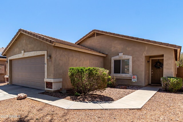 single story home featuring an attached garage, driveway, and stucco siding