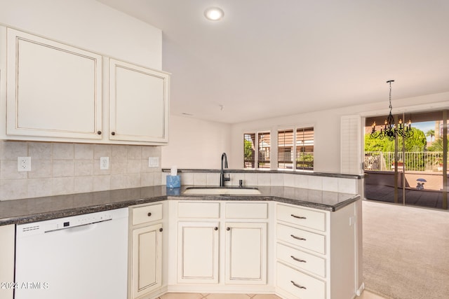 kitchen featuring dishwasher, sink, a notable chandelier, kitchen peninsula, and light colored carpet