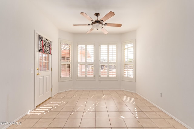 spare room featuring ceiling fan and light tile patterned floors