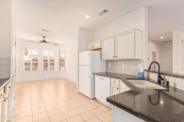 kitchen featuring white appliances, ceiling fan, sink, light tile patterned floors, and dark stone countertops