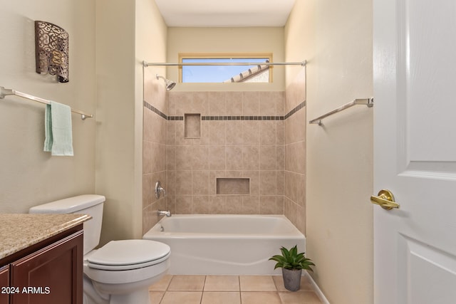 full bathroom featuring tiled shower / bath, tile patterned flooring, vanity, and toilet