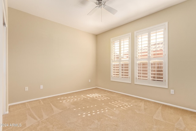 carpeted empty room featuring ceiling fan